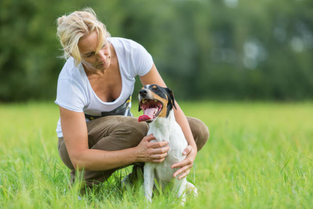 istock woman plays with her dog 685798810