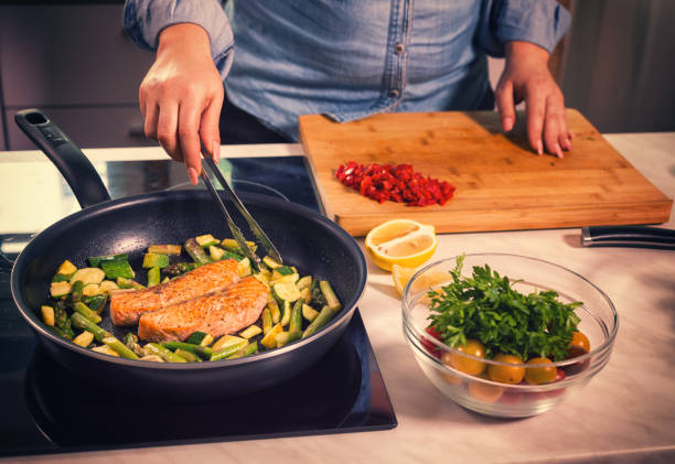 istock Young Women Preparing Salmon at Home 685800146