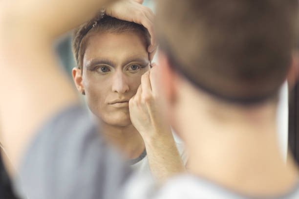 istock Man gets dressed in drag attire in bathroom 685800304