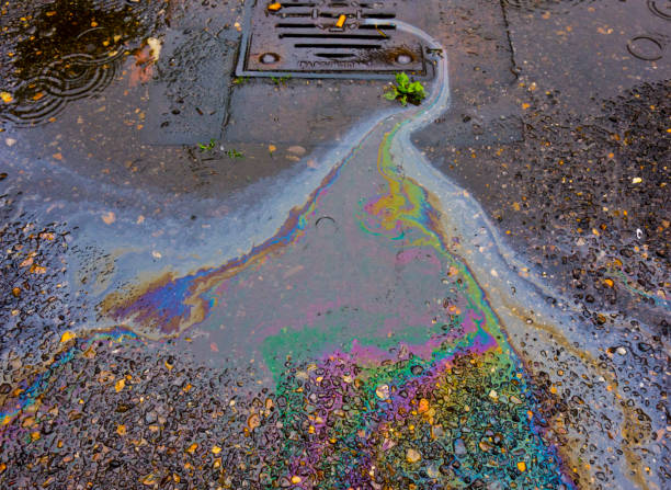 Petrol Oil In Water Running Down the Drain