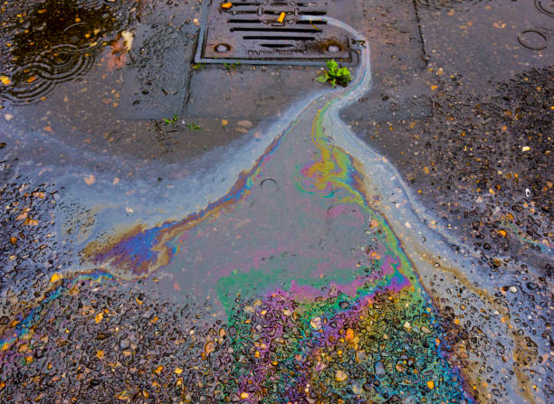 Petrol Oil In Water Running Down the Drain stock photo