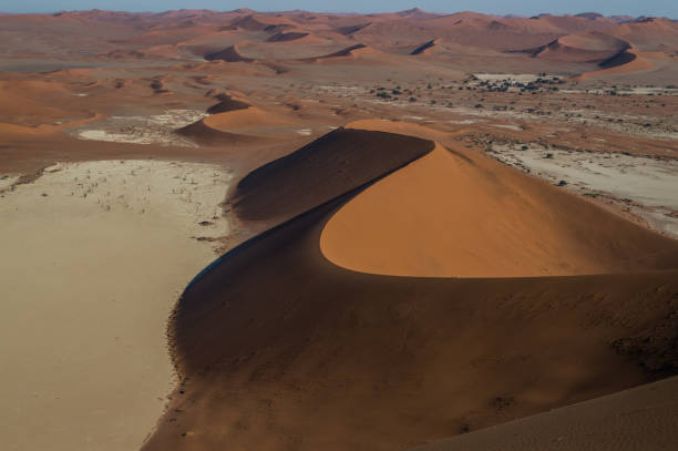 istock Climbing Big Daddy Dune during Sunrise, Looking onto Sossusvlei Salt Pan, Desert Landscape, Namibia 685807748
