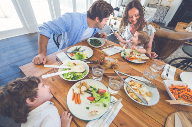 istock Little girl feeding her father. 685808152