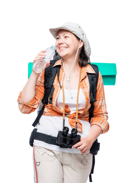 woman with a bottle of water and a heavy backpack on a white background woman with a bottle of water and a heavy backpack on a white background voyager 1 stock pictures, royalty-free photos & images
