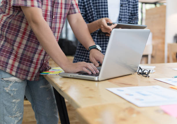 istock startup young successful team on meeting in modern office interior brainstorming, make a business plan, working on laptop computer and tablet with financial and marketing graph and chart 685809800
