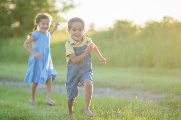 istock Sister Chasing her Brother in the Sun 685810566