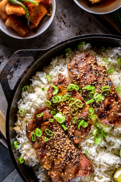 istock Delicious Grilled Kalbi on over Steamed Rice in Cast Iron Pan 685811744