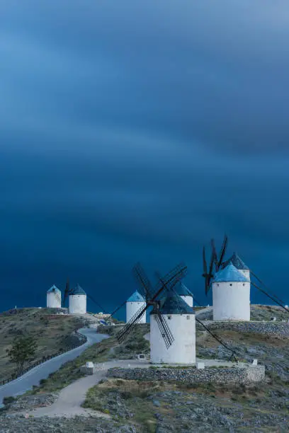 Evening clouds and medieval windmills on hill top, Consuegra,Spain