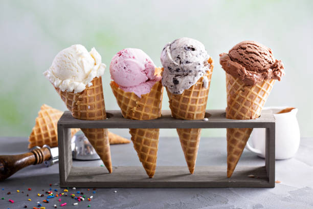Variety of ice cream cones Variety of ice cream scoops in cones with chocolate, vanilla and strawberry ice cream stock pictures, royalty-free photos & images