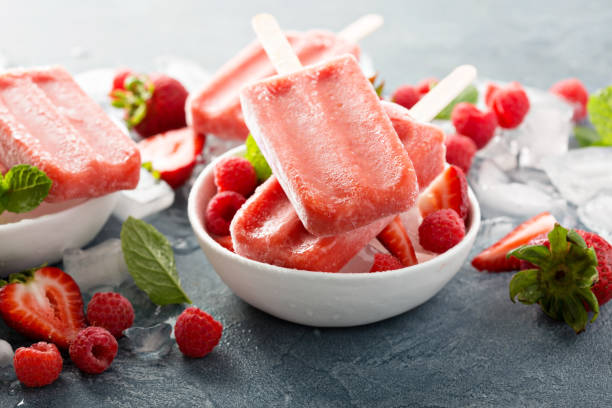 Strawberry and raspberry popsicles Strawberry and raspberry ice cream popsicles in white bowls flavored ice photos stock pictures, royalty-free photos & images