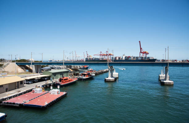 Fremantle,WA,Australia-November 13,2016: Nautical vessels, jetty, port and commercial dock, with shipping containers and cranes in Fremantle, Western Australia.