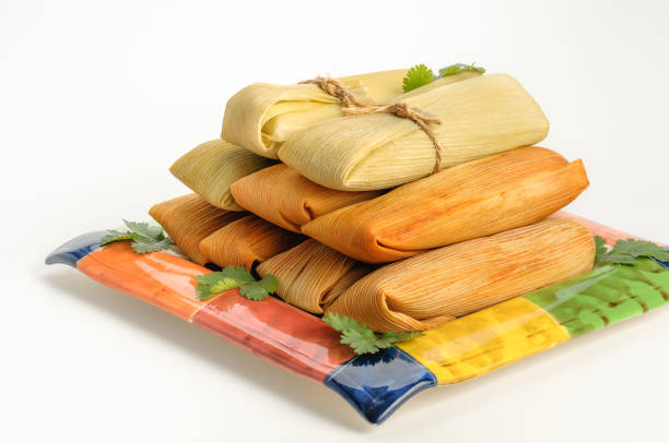 Mexican tamales made of corn and chicken isolated on white stock photo