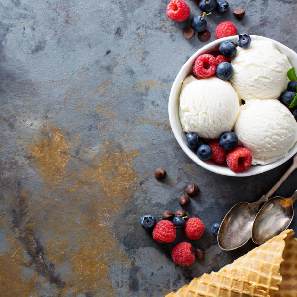 istock Vanilla ice cream scoops in a bowl with fresh berries 685820574
