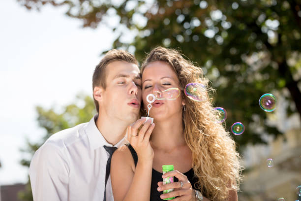 istock young couple blowing soap bubbles in summer 685821448