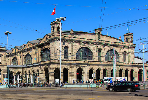 Zurich, Switzerland - 11 April, 2016: building of the Zurich main railway station, people at it. Zurich main railway station is the largest railway station in Switzerland and one of the busiest railway stations in the world.
