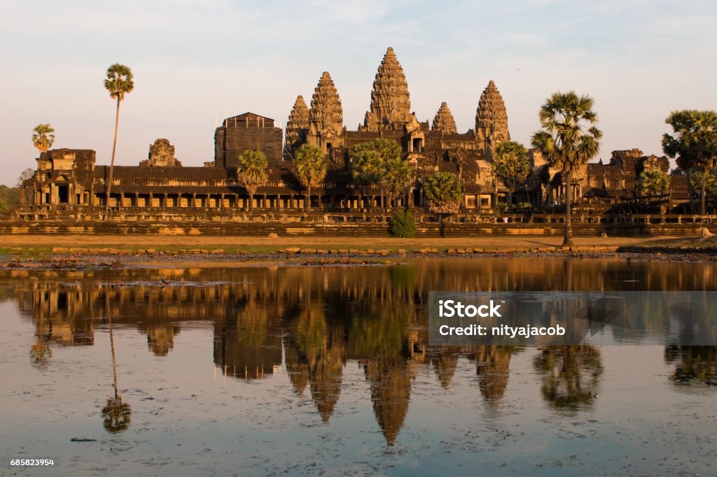 Sound at Angkor Wat The sunset paints Angkor Wat a brilliant orange that is reflected in the pond Angkor Wat Stock Photo