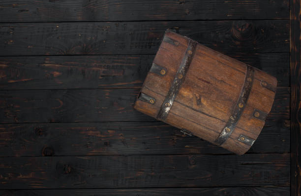 Old closed chest close up on dark wooden table with copy space, top view