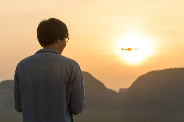 istock Young man flying drone and capture beautiful morning sunrise 685828478