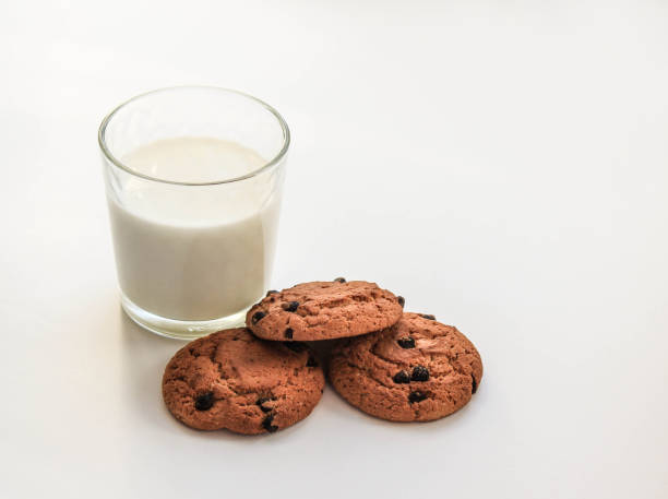 istock Milk in a glass with oatmeal cookies on a white table 685833480