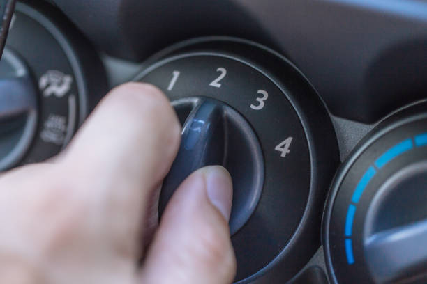 istock closeup hand at car cooling air conditioner fan speed adjust. 685836780