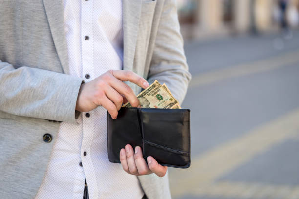 istock man hand take out dollar bill banknote from his wallet on street 685836784