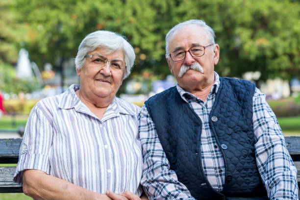senior couple sitting on a bench