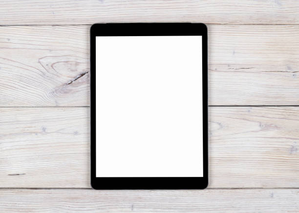 istock Tablet computer PC with blank screen mock up isolated on white wood table background. Tablet on wood table. tablet white screen 685840280