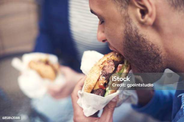 Close Up Of Man Eating Cheeseburger Stock Photo - Download Image Now - Eating, Men, Unhealthy Eating