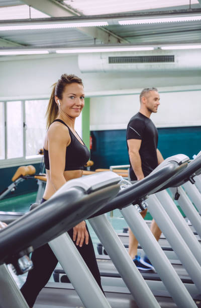 istock Woman with earphones training over a treadmill 685842090