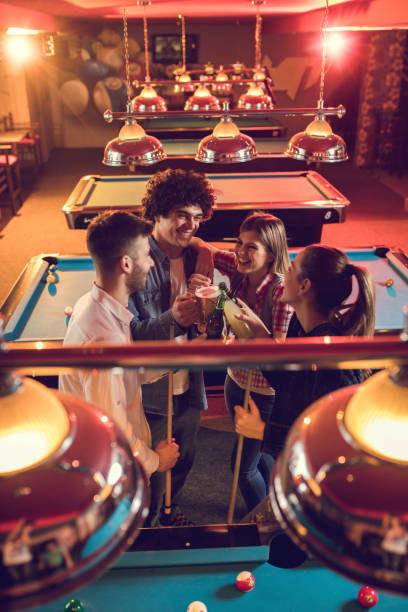 istock Above view of cheerful friends having fun while toasting in a pool hall. 685844174