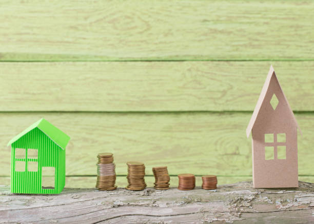 istock paper house on green wooden background 685844202