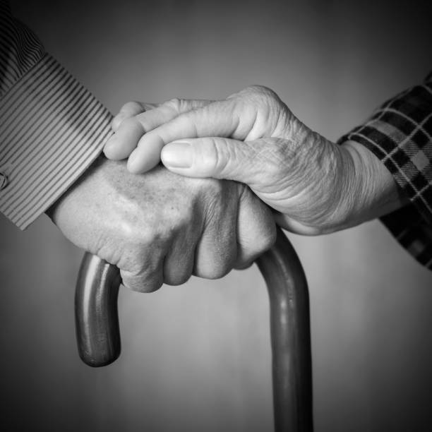 istock care:Senior couple holding hands 685845026