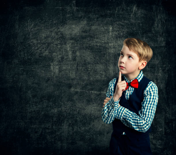 istock Kid Thinking Over School Blackboard, Child Boy Think Looking Side Finger on Mouth, Children Education 685847664