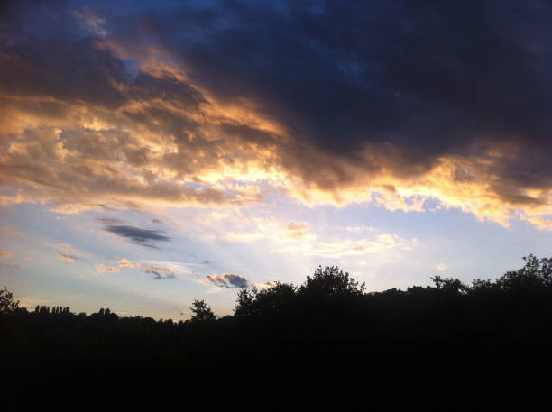 istock dark blue sky with many golden clouds over the hill 685847760