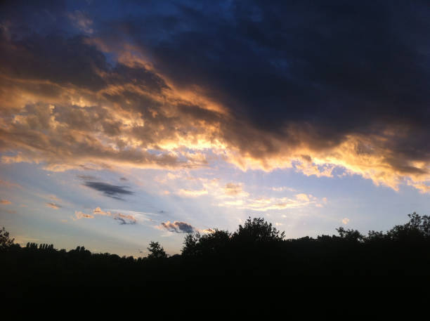 istock dark blue sky with many golden clouds over the hill 685848004
