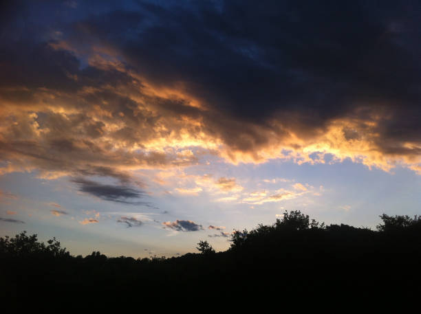 istock dark blue sky with many golden clouds over the hill 685848034