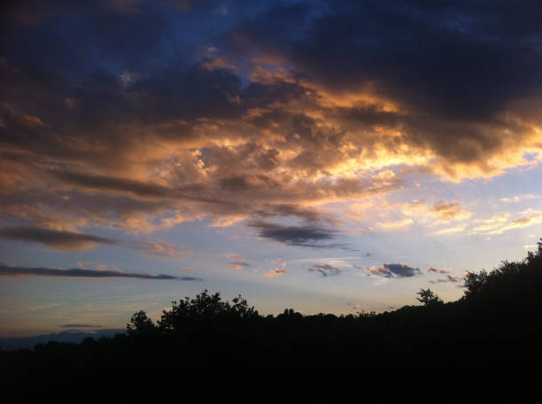 istock dark blue sky with many golden clouds over the hill 685848688