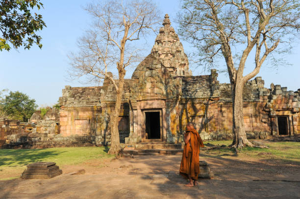 Phanom Rung: monk walking in front of Phanom Rung hindu temple on Thailand