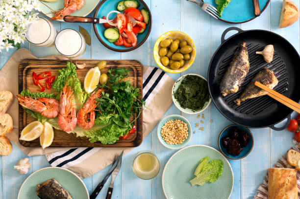 istock Dinner table with shrimp, fish grilled, salad, different snacks and lager beer 685852928