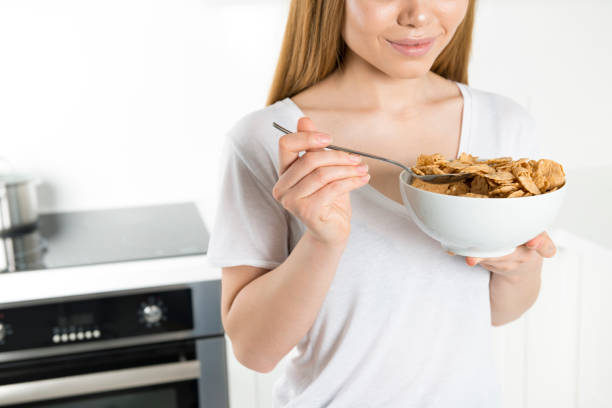 istock Young woman eating cornflakes 685853534