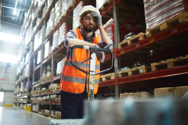 Tired of work Tired worker with forklift touching his forehead tired stock pictures, royalty-free photos & images