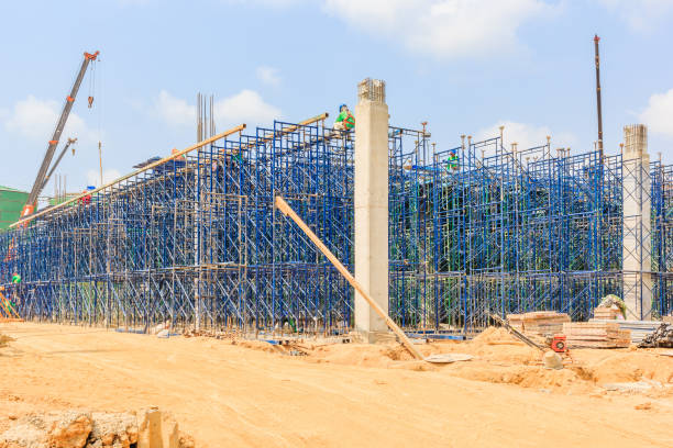 istock Construction workers wearing safety harness and installing scaffolding at high level in the construction site. 685855798