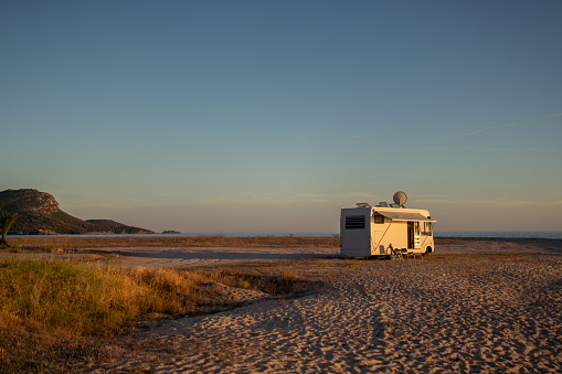 Camping trailer on the sandy beach at the seaside