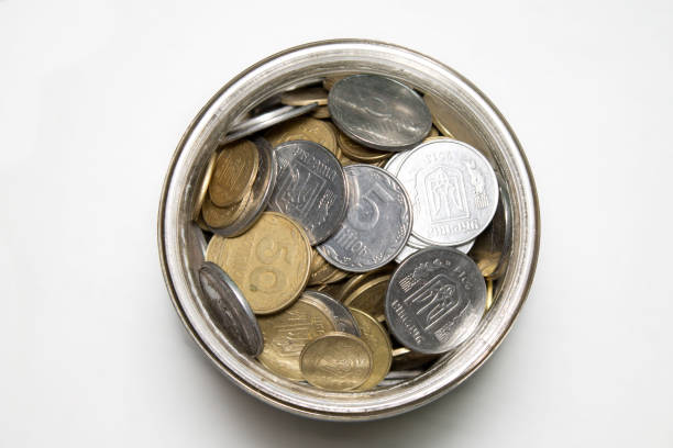 coins in bottle on white background top shot