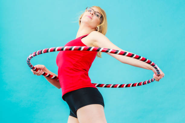 istock Fit woman with hula hoop doing exercise 685862668