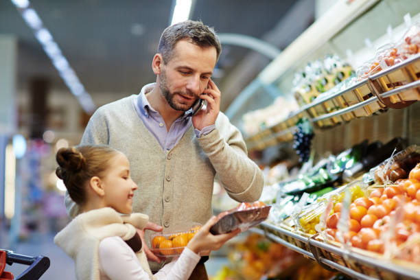 istock Man Calling Wife from Grocery Store 685863314