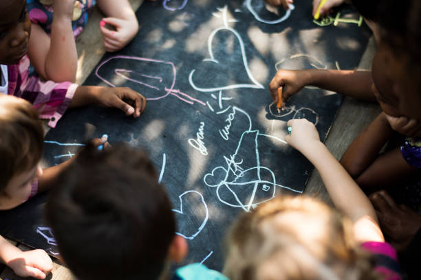 istock Kindergarten kids chalk drawing on blackboard 685864186