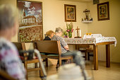 Senior Women Praying In The Chapel Of The Nursing Home