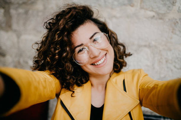 istock Curly-haired girl with nose ring is taking a selfie 685864772