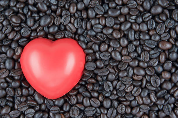 istock Red heart shape place on black roasted coffee beans 685865880